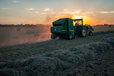 Photo by Jed Owen green farm heavy equipment on green field